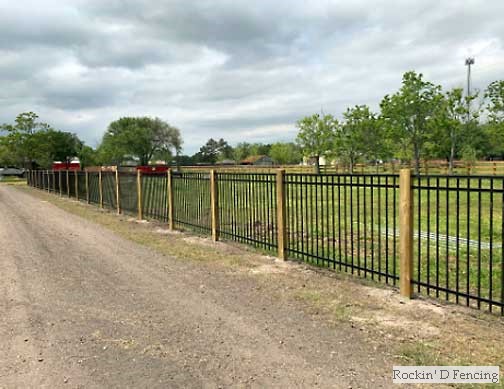 Wrought iron agricultural fencing with 6X6 wood posts