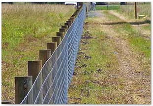 Field fence with round timber style poles